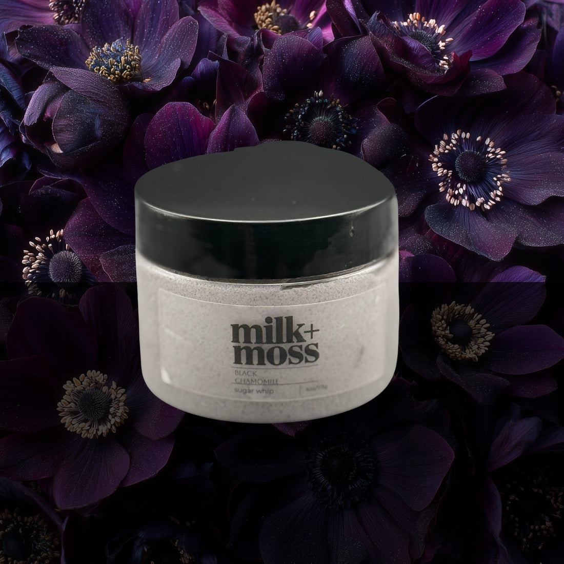 Jar of 'milk+moss' scrub on a dark floral background